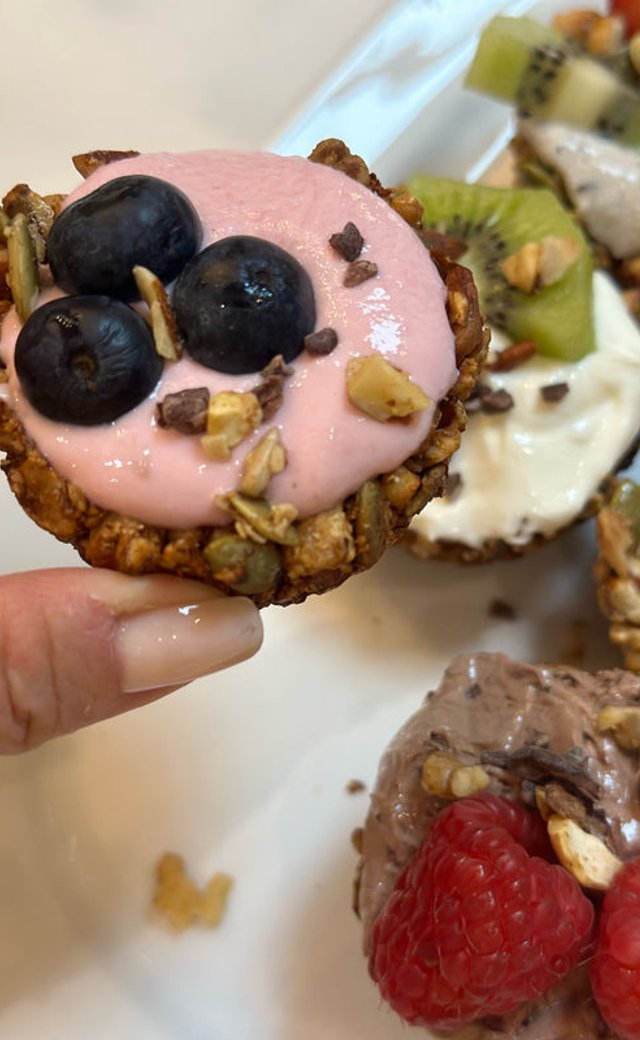 Granola cups filled with yogurt and topped with fresh blueberries